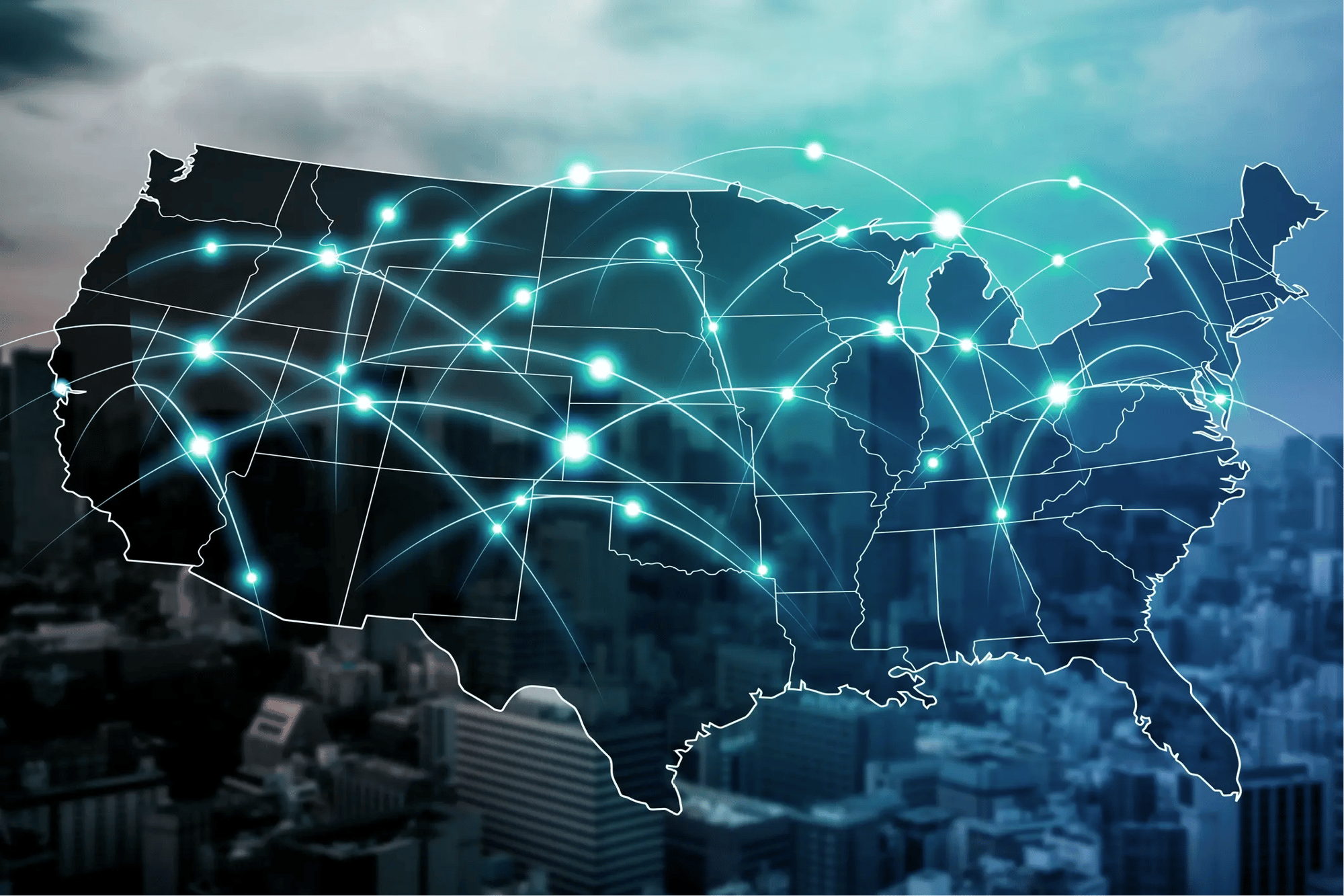 Illuminated map of the United States showing interconnected nodes and network lines across states, representing nationwide technology coverage, overlaid on a city skyline background.